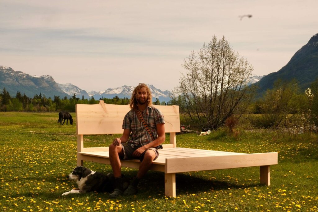 Image of Me sitting on a bed frame I made