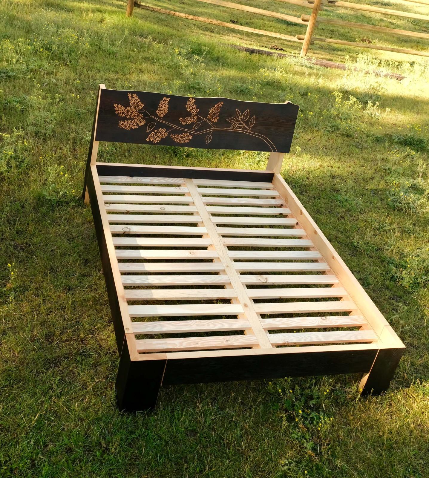 Fire-charred Douglas fir surface of the Lilac bed frame, showing the burnt wood texture sealed in oil varnish