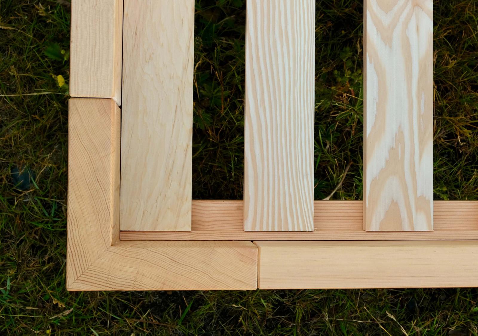 Carved corner post of the Lilac bed frame in fire-charred Douglas fir